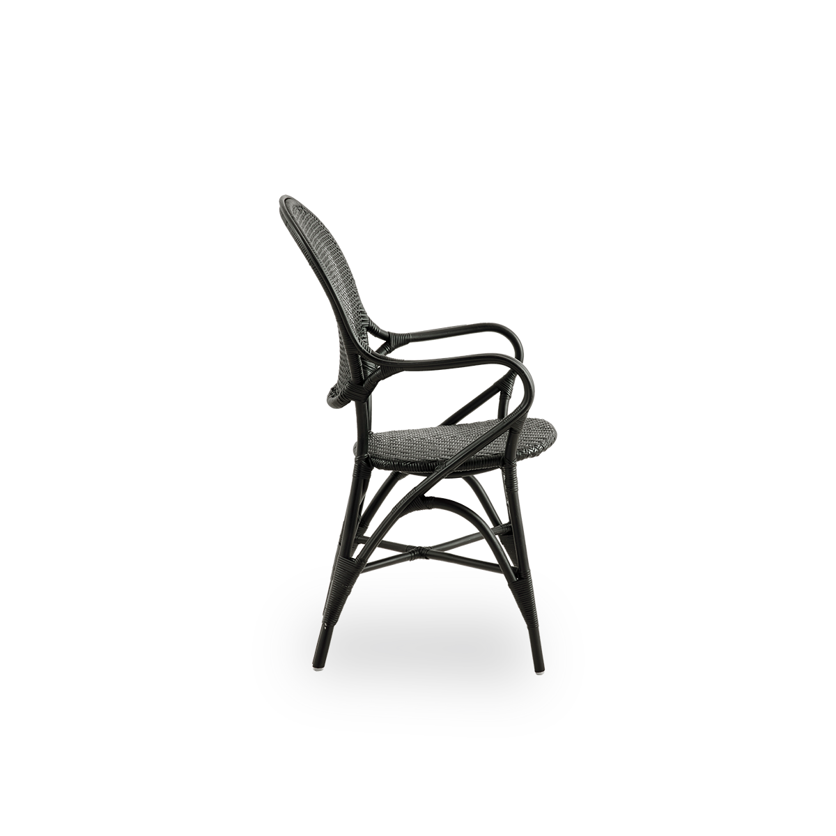 Plain side view of Rossini dining armchair in black color. Elegant wicker chair with round backrest and armrests in simple design. Handcrafted from high quality rattan.