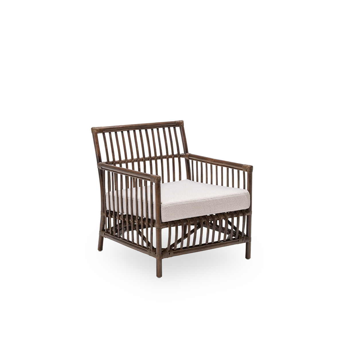 Side view of the Caroline lounge chair with seat cushion, in brown rattan. A simple and elegant Danish design whose detailed windings make it a quiet element in the room. Handcrafted from high-quality Indonesian rattan.