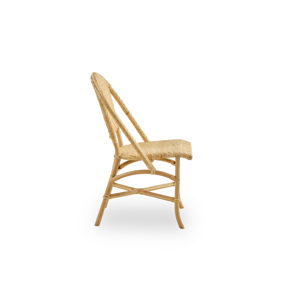 Plain side view of Alanis dining chair in high quality natural rattan, featuring elegant curves and detailed weaving.