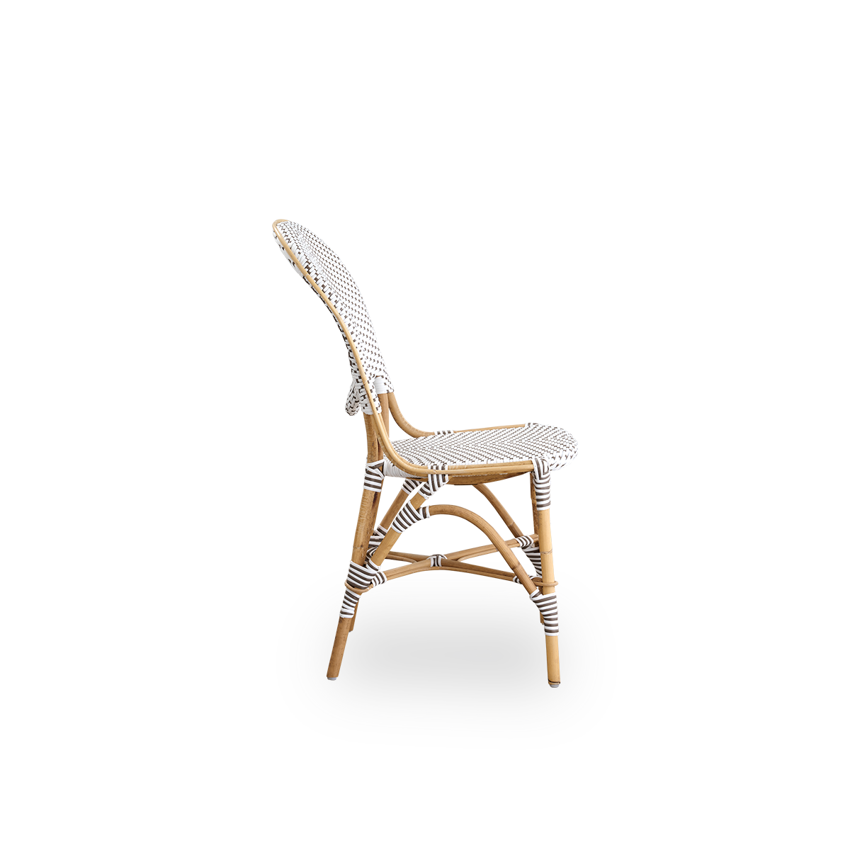 Plain side view of Isabell dining chair. Rattan frame with seat and backrest made in white ArtFibre with brown dots. Inspired by 1950s bistro design.