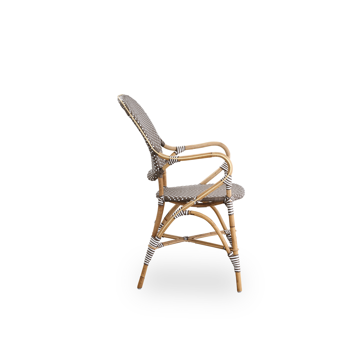 Plain side view of Isabell dining chair with armrest. Rattan frame with seat and backrest made in brown ArtFibre with white dots. Inspired by 1950s bistro design.