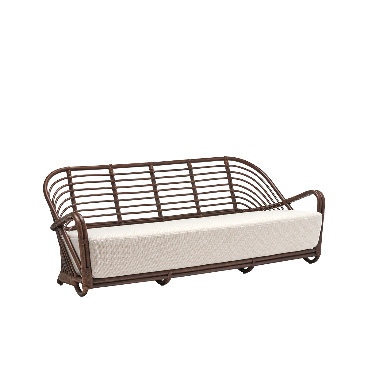 Side view of the Charlottenborg 3-seater sofa with seat cushion, in brown rattan. Originally designed by Arne Jacobsen in 1936, its gracefully curved backrest flows seamlessly into the armrests. Handcrafted in rattan.