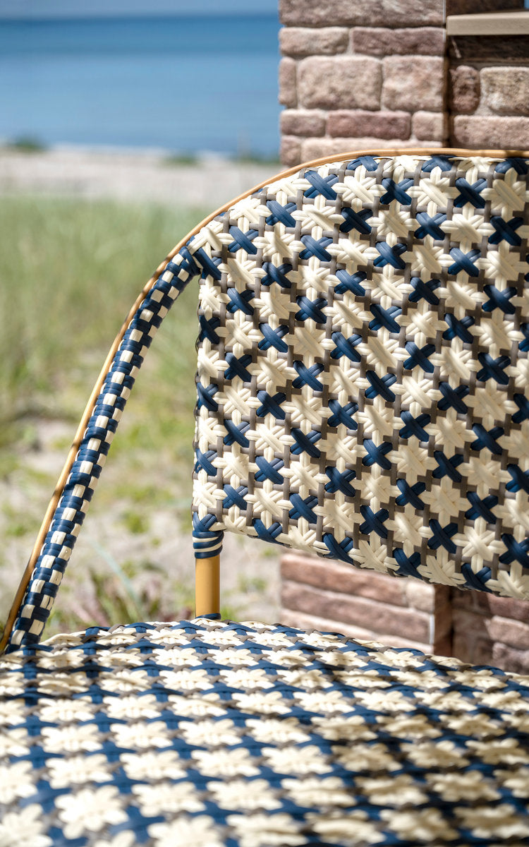 This is a close-up image of Sofie Exterior 6-Seater Bench in almond aluminium frame starweave ivory navy blue cappuccino artfibre. Weave detail.