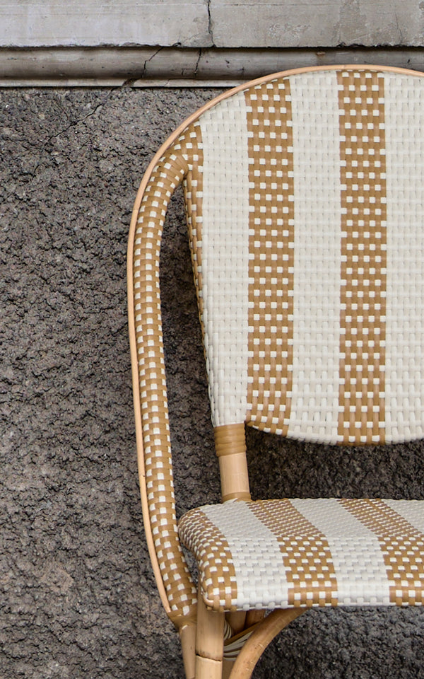 This is a close-up image of Sofie Dining Chair in striped honey ivory artfibre skin on natual rattan frame.