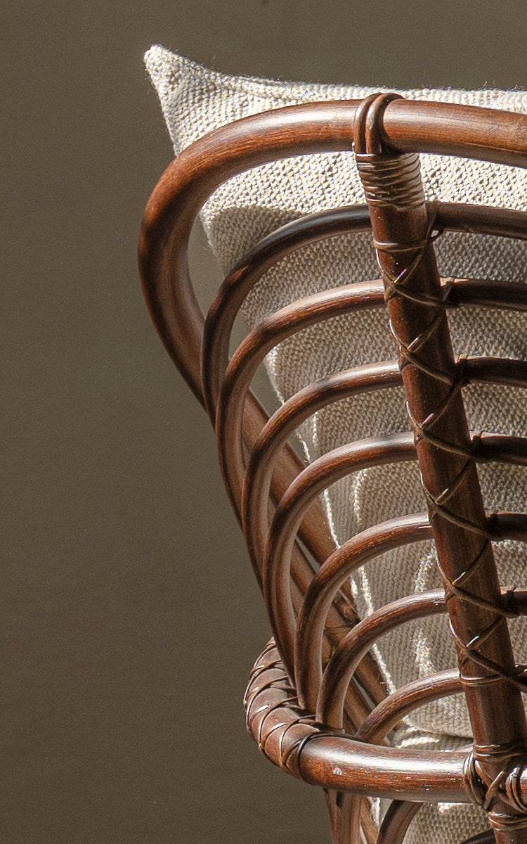 This is a close-up image of Charlottenborg 3-Seater Sofa in brown rattan. Curved rattan back with bound joints.