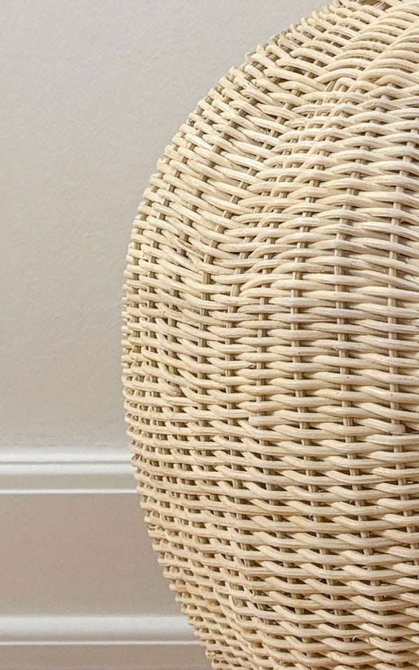 This is a close-up image of Flumen Basket in natural core weave iron frame.
