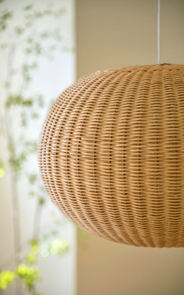 This is a close-up image of Tangelo Lampshade Ø49 cm-Medium in natural core weave iron frame. Round woven shade hanging by a sunlit window.