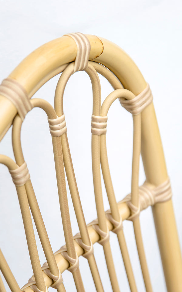 This is a close-up image of Margret Exterior Side Chair in natural aluminium artfibre. Arched backrest with looped ArtFibre spindles.