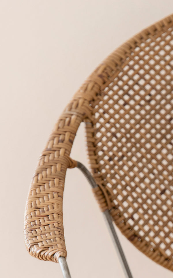 This is a close-up image of Funky Dining Chair in hazelnut rattan iron frame.