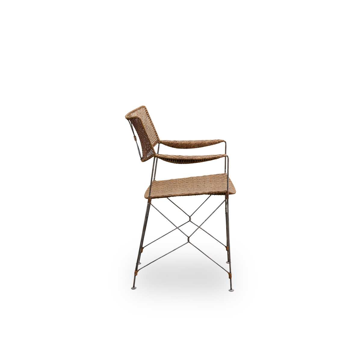 Plain side view of Rap dining chair designed by Yuzuru Yamakawa. Steel frame with seat and backrest handwoven with Indonesian rattan, lightweight chair combining Japanese design with traditional indonesian craftsmanship.
