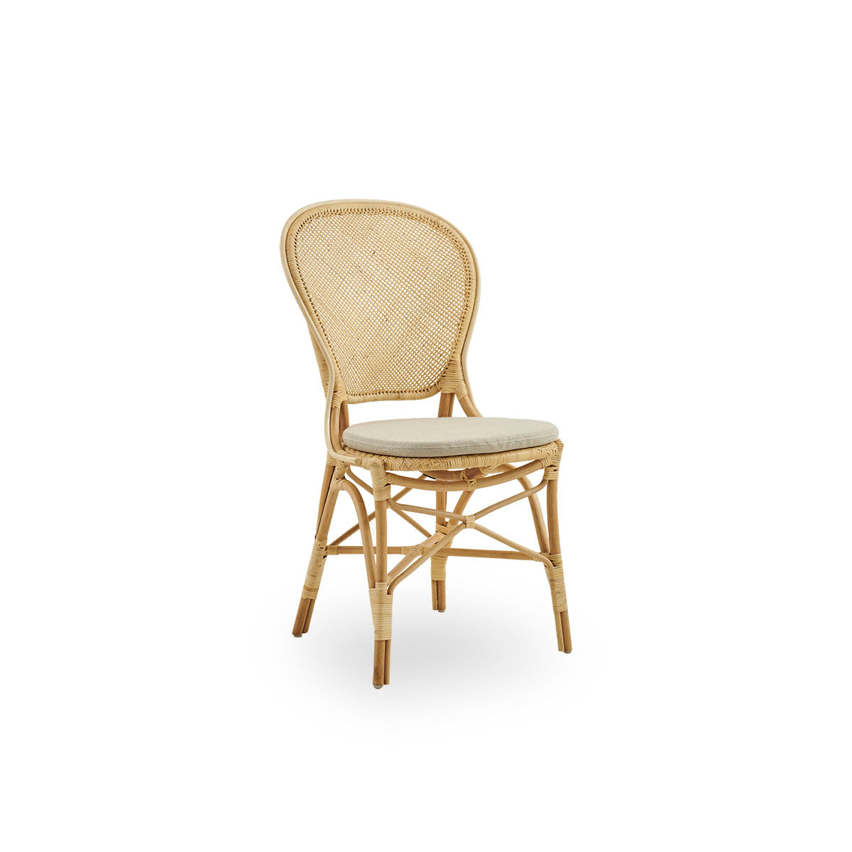 Side view of Rossini dining chair in natural rattan. Elegant wicker chair with round backrest in simple design. Handcrafted from high quality rattan.