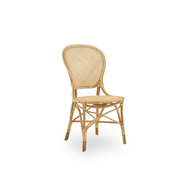 Side view of Rossini dining chair in natural rattan. Elegant wicker chair with round backrest in simple design. Handcrafted from high quality rattan.