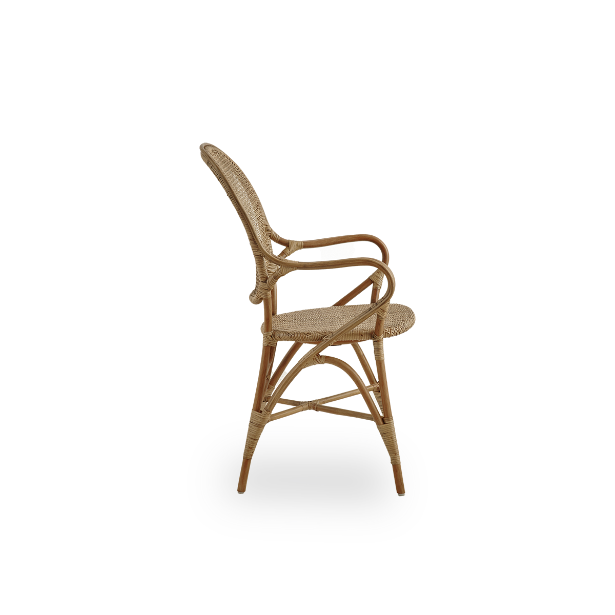 Plain side view of Rossini dining armchair in antique brown color. Elegant wicker chair with round backrest and armrests in simple design. Handcrafted from high quality rattan.
