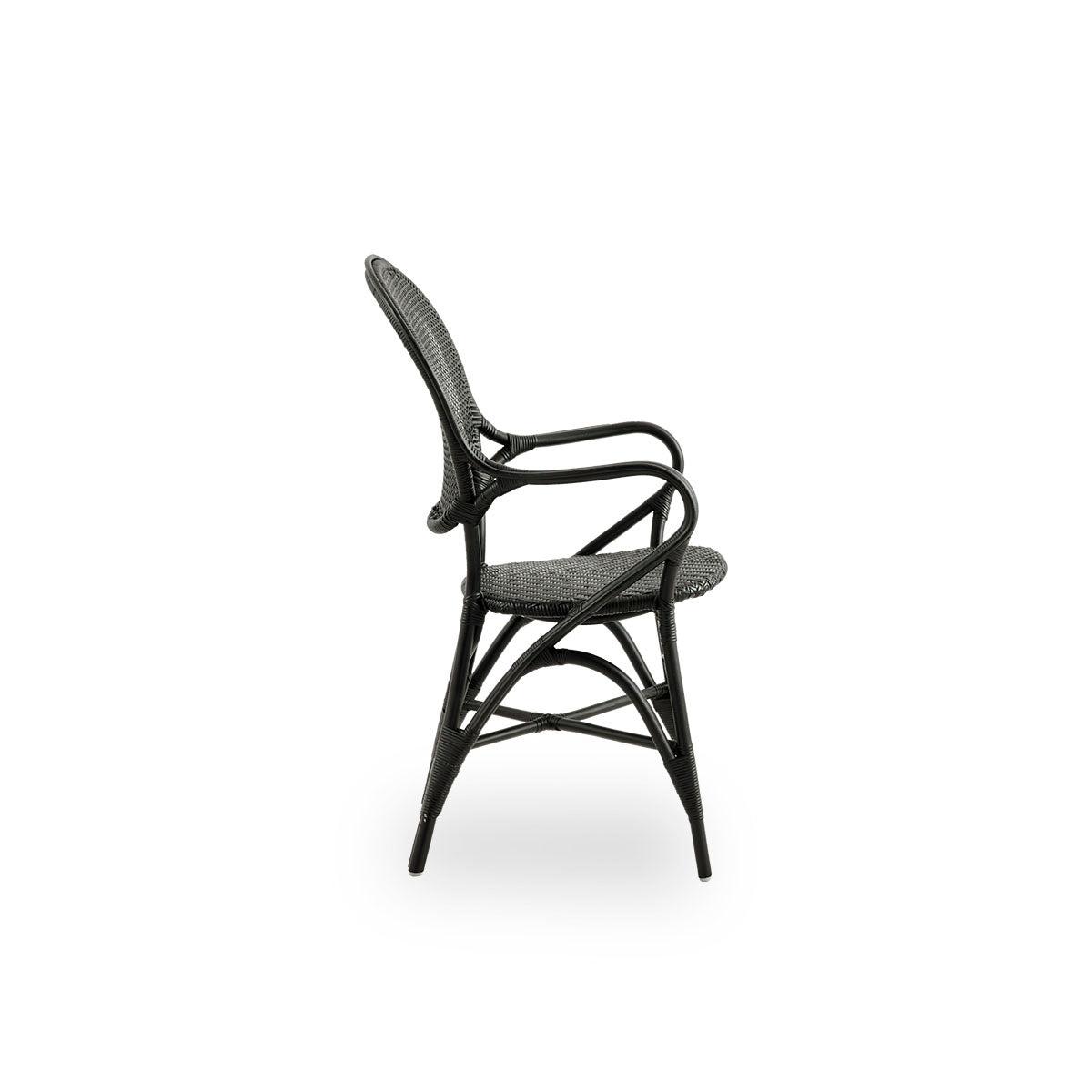 Plain side view of Rossini dining armchair in black color. Elegant wicker chair with round backrest and armrests in simple design. Handcrafted from high quality rattan.