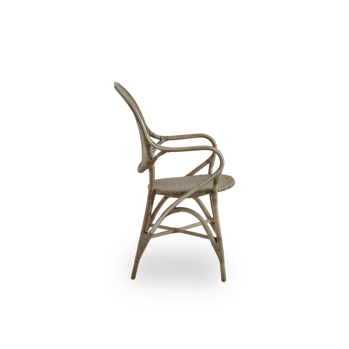 Plain side view of Rossini dining armchair in Taupe color. Elegant wicker chair with round backrest and armrests in simple design. Handcrafted from high quality rattan.