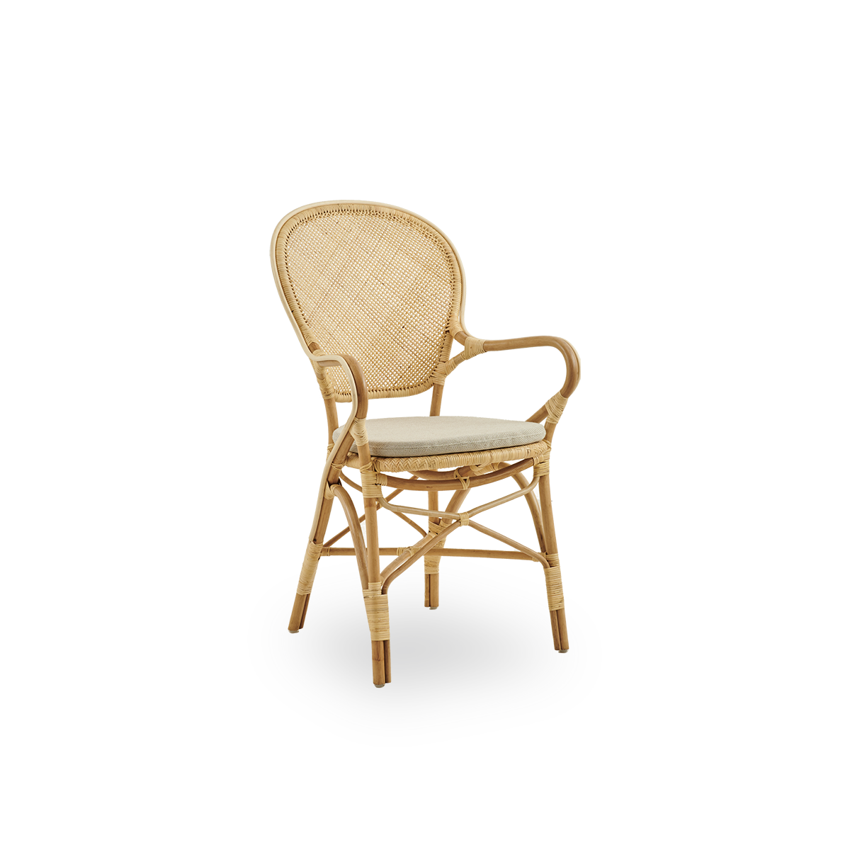 Side view of Rossini dining armchair made in natural rattan. Elegant wicker chair with round backrest and armrests in simple design. Handcrafted from high quality rattan.
