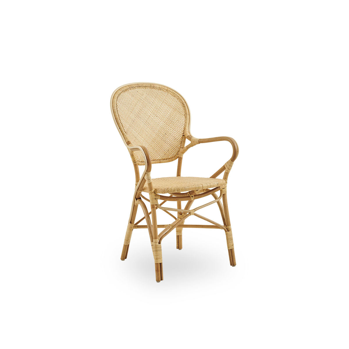 Side view of Rossini dining armchair made in natural rattan. Elegant wicker chair with round backrest and armrests in simple design. Handcrafted from high quality rattan.