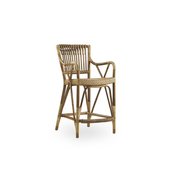 Side view of Blues Counter stool in antique brown color made of Indonesian rattan. Handwoven seat on a rattan frame with rattan back rest.