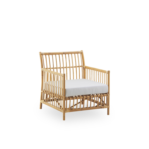 Side view of Caroline Lounge Chair, simple and elegant Danish design. Handcrafted from Indonesian rattan. The chair has a cozy, calming presence.