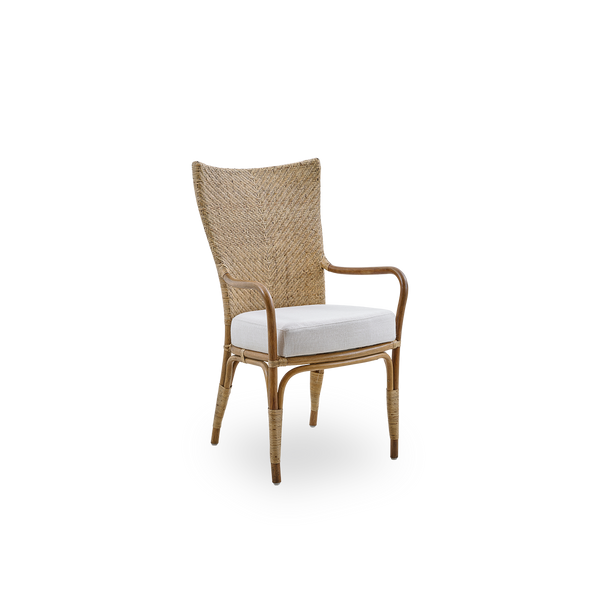 Side view of Melody dining armchair in Antique rattan color with high fully woven rattan backrest and upholstery seat.