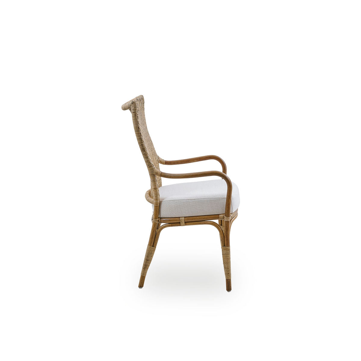 Plain side view of Melody dining armchair in Antique rattan color with high fully woven rattan backrest and upholstery seat.
