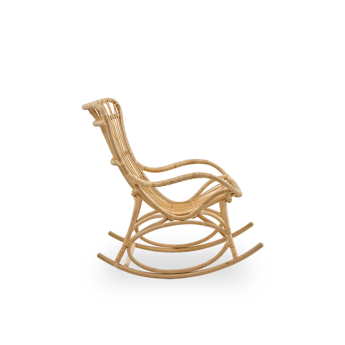 Plain side view of Monet rocking chair with high backrest and armrests presented in natural rattan. Handcrafted from high-quality Indonesian rattan.