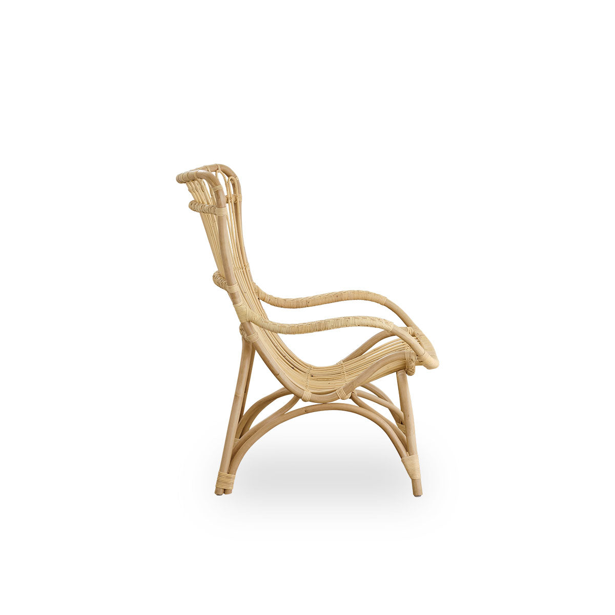 Plain side view of Monet lounge chair with high backrest and armrests presented in natural rattan. Handcrafted from high-quality Indonesian rattan.