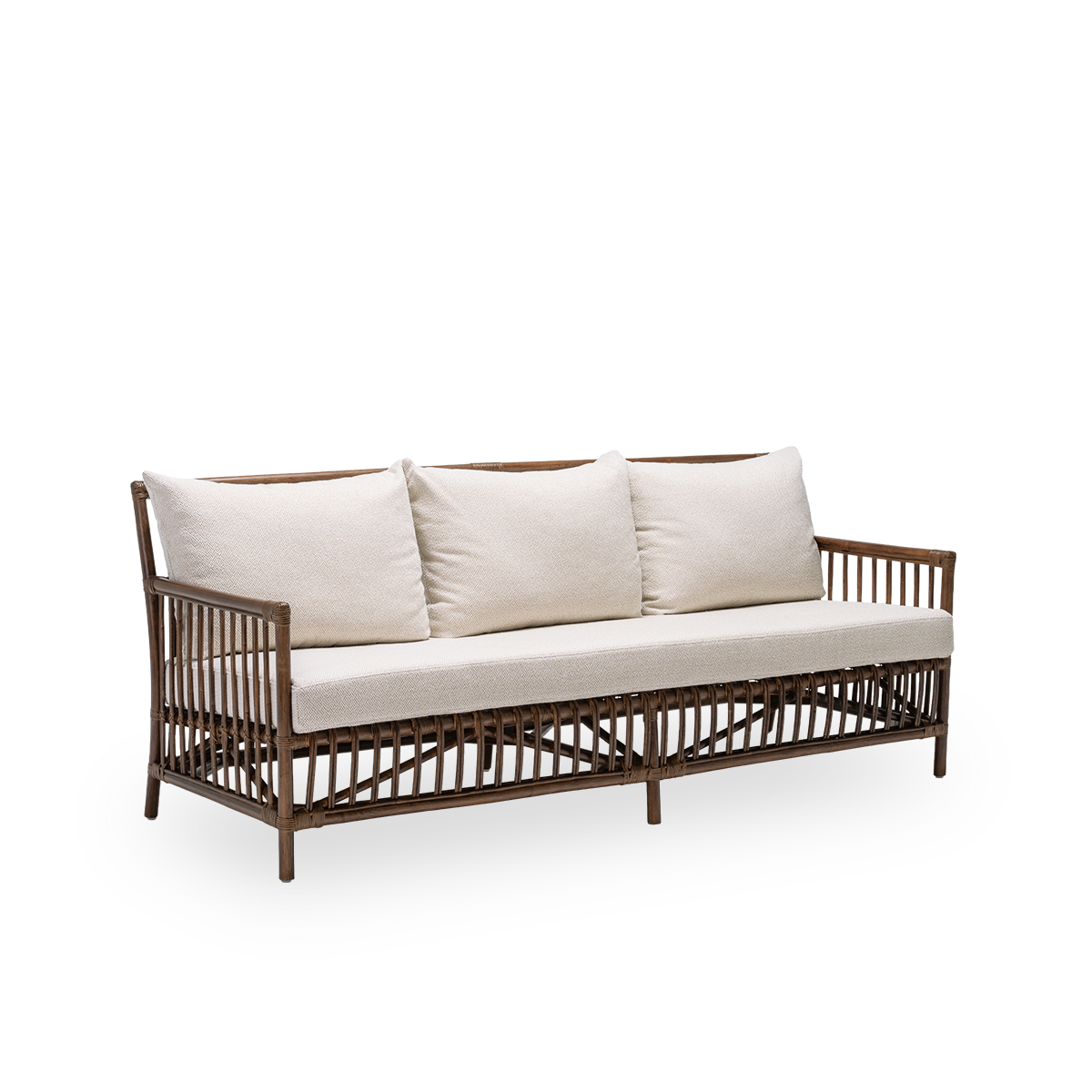 Side view of the Caroline sofa with seat and back cushions, in brown rattan. A simple and elegant Danish design whose detailed windings make it a quiet element in the room. Handcrafted from high-quality Indonesian rattan.