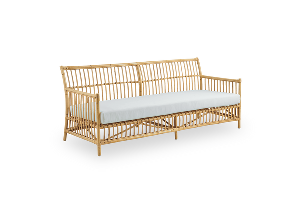 Side view of Caroline 3-seater wicker sofa, simple and elegant Danish design. Handcrafted from Indonesian rattan with detailed woven accents for a cozy, calming presence.