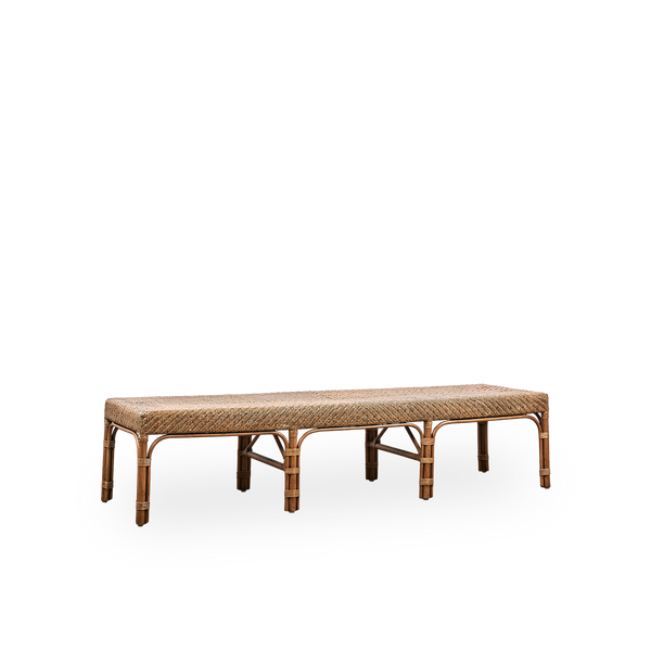 Side view of Luis bench handcrafted from high-quality Indonesian rattan in Antique brown color. Elegant design with finely woven seat. Length 180 cm.