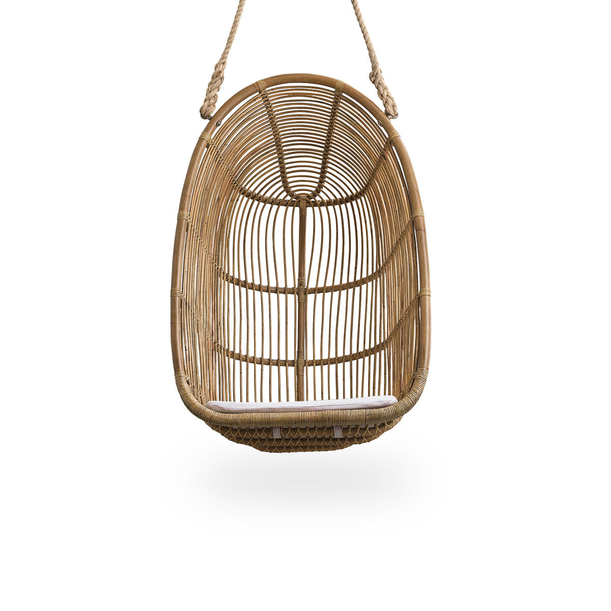 Front view of the Renoir hanging chair in antique brown color handcrafted in high-quality rattan.
Soft, embracing shape suspended with strong rope.