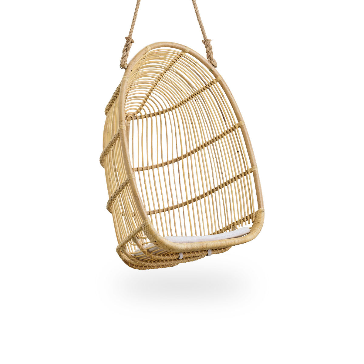 Side view of Renoir hanging chair in Natural color handcrafted in high quality rattan. Soft, embracing shape suspended with strong rope.