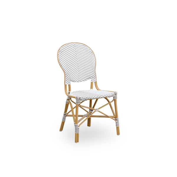 Side view of Isabell outdoor dining chair. Almond colored aluminium frame with seat and backrest made in white ArtFibre with brown dots. Inspired by 1950s bistro design.