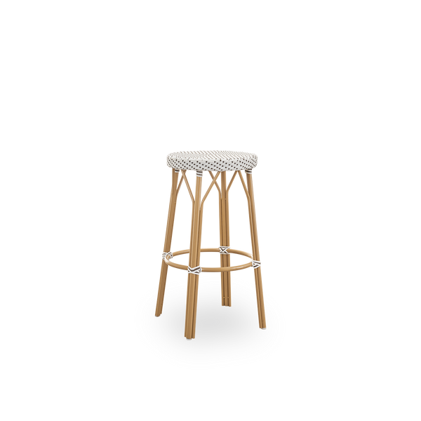 Side view of Simone outdoor barstool height 78 cm. Aluminium frame in Almond color with footrest, with fully woven round seat handcrafted in ArtFibre in white with brown dots pattern. Stackable barstool.