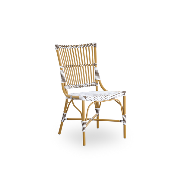 Side view of Monique outdoor dining chair. Aluminium frame in almond color with seat woven with ArtFibre in white with brown dots. Inspired by 1950s bistro design.