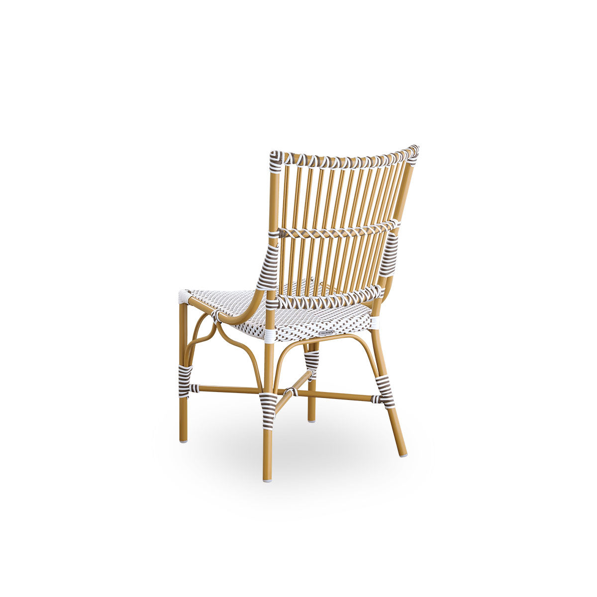 Back side view of the Monique outdoor dining chair.
Aluminum frame in almond color with seat woven with ArtFibre in white with brown dots. Inspired by 1950s bistro design.