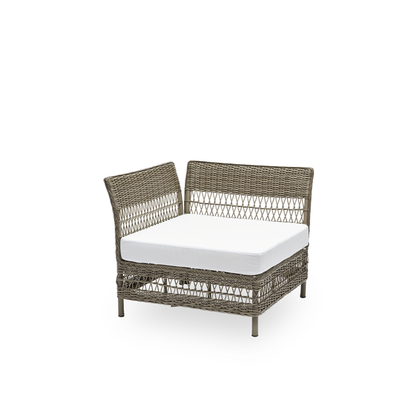 Side view of the Mona exterior sofa, corner module with seat cushion, in antique grey ArtFibre and aluminium. Part of the Mona modular sofa, which adapts to the shape of the outdoor space it stands in.