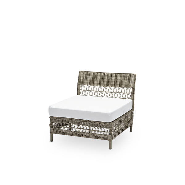 Side view of the Mona exterior sofa, center module with seat cushion, in antique grey ArtFibre and aluminium. Part of the Mona modular sofa, which adapts to the shape of the outdoor space it stands in.