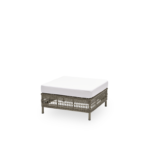 Side view of the Mona exterior sofa, pouf module with seat cushion, in antique grey ArtFibre and aluminium. Part of the Mona modular sofa, usable as a footstool, an extra seat or a low table.