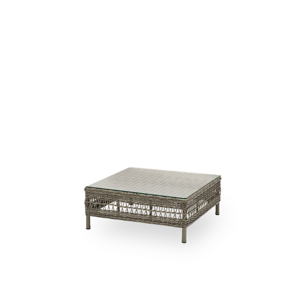 Side view of the Mona exterior sofa, pouf module with glass top, in antique grey ArtFibre and aluminium. Part of the Mona modular sofa, usable as a footstool, an extra seat or a low table.