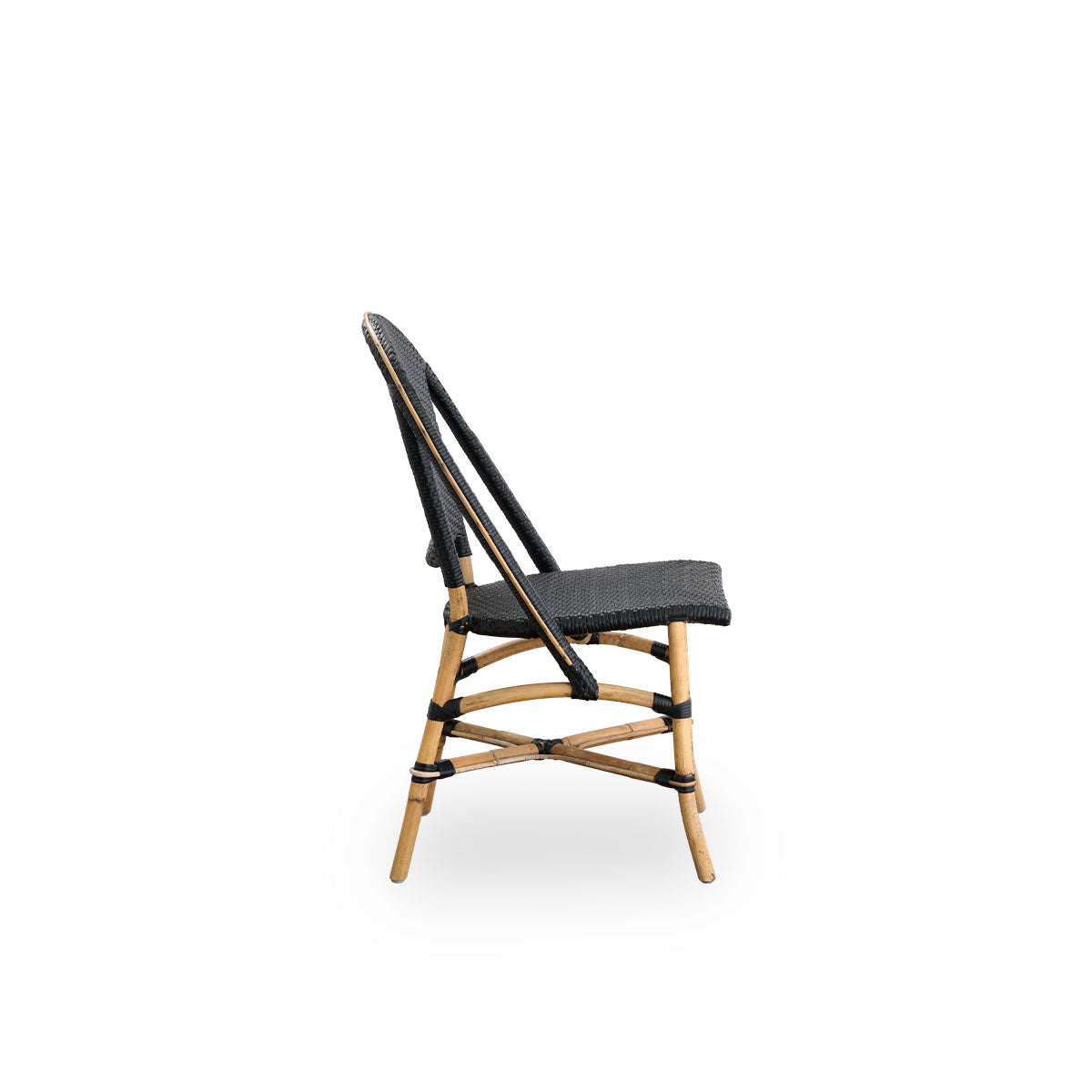 Plain side view of Sofie rattan dining chair inspired by French café style. Rattan frame with fully woven seat- and backrest handcrafted in ArtFibre in black color. Stackable rattan bistro chair.