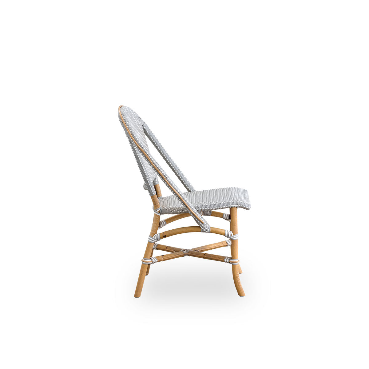 Plain side view of Sofie rattan dining chair inspired by French café style. Rattan frame with fully woven seat- and backrest handcrafted in ArtFibre in grey with white dots pattern. Stackable rattan bistro chair.