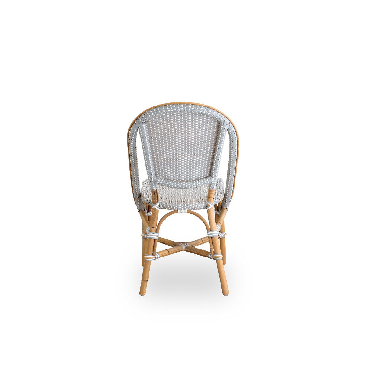 Plain back view of Sofie rattan dining chair inspired by French café style. Rattan frame with fully woven seat and backrest handcrafted in ArtFibre in grey with white dots pattern. Stackable rattan bistro chair.