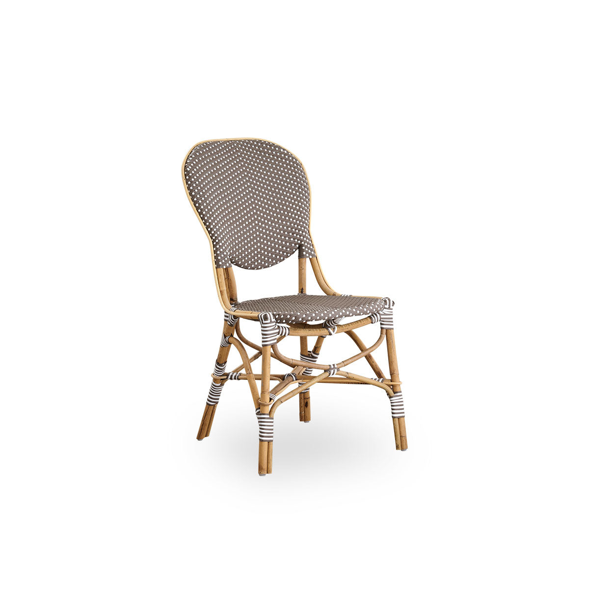 Side view of Isabell dining chair. Rattan frame with seat and backrest made in brown ArtFibre with white dots. Inspired by 1950s bistro design.