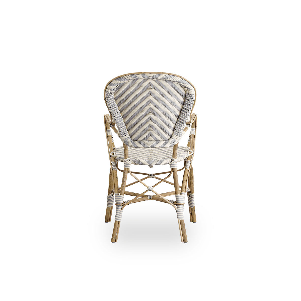 Plain back view of Isabell dining chair with armrest. Rattan frame with seat and backrest made in ArtFibre in ivory and grey herringbone pattern. Inspired by 1950s bistro design.
