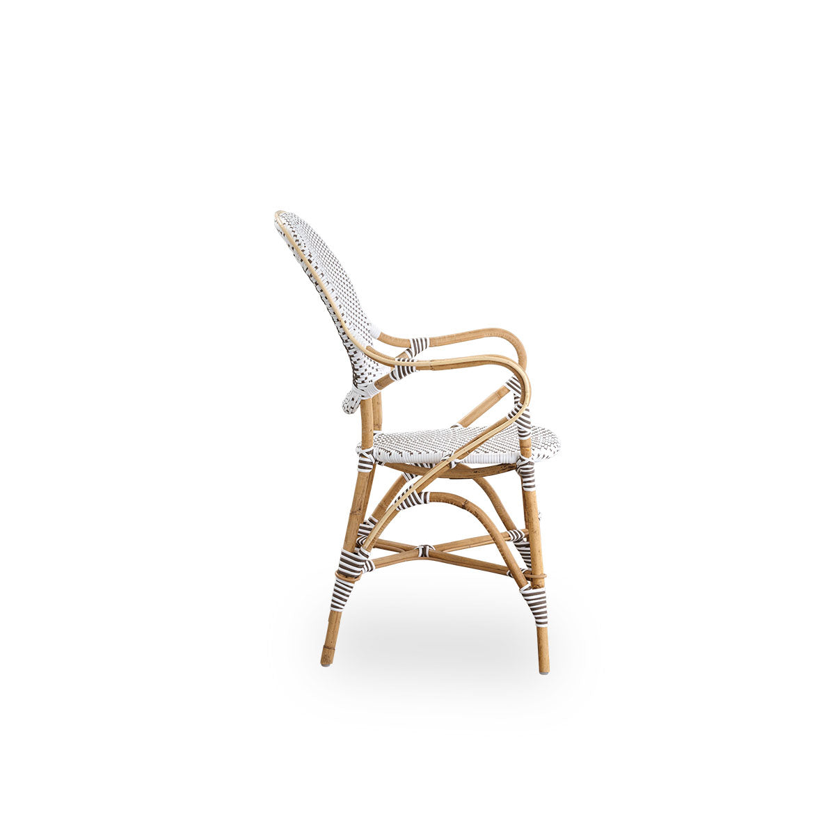 Plain side view of Isabell dining chair with armrest. Rattan frame with seat and backrest made in white ArtFibre with brown dots. Inspired by 1950s bistro design.