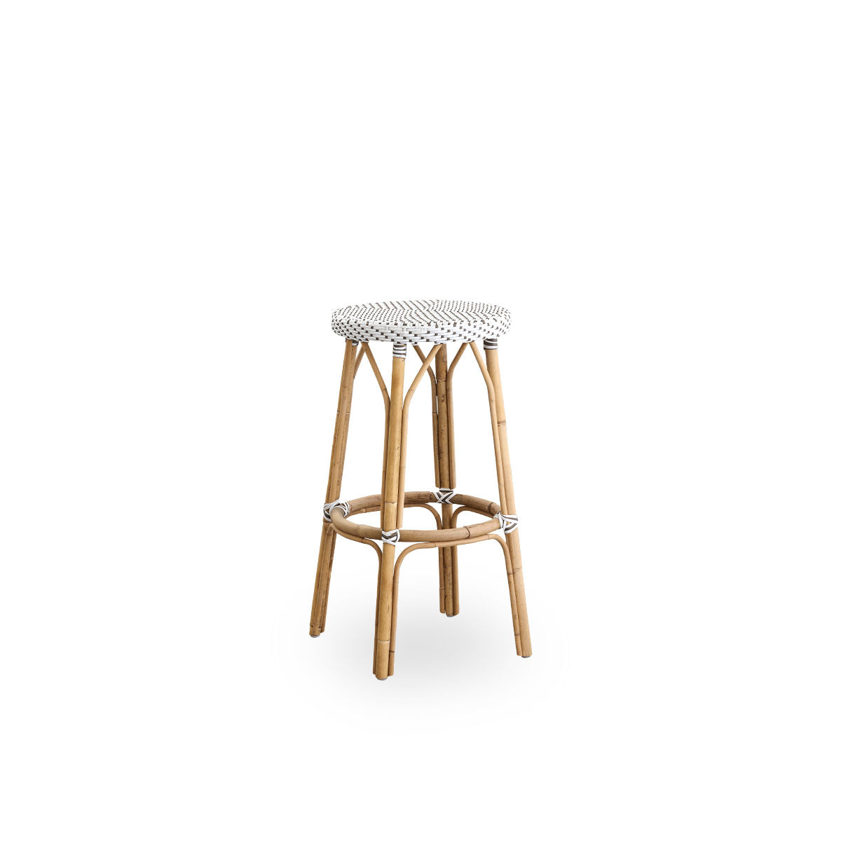 Side view of Simone barstool height 78 cm. Rattan frame with footrest, with fully woven round seat handcrafted in ArtFibre in white with brown dots pattern. Stackable barstool.