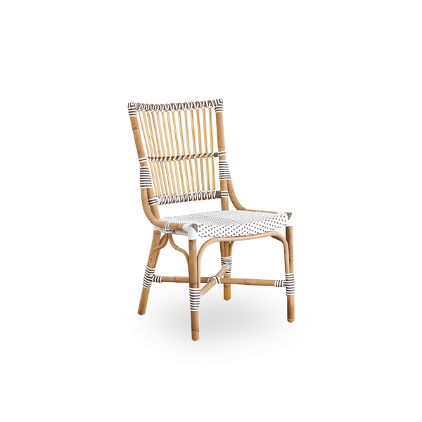 Side view of Monique dining chair. Rattan frame with seat woven with ArtFibre in white with brown dots. Inspired by 1950s bistro design.