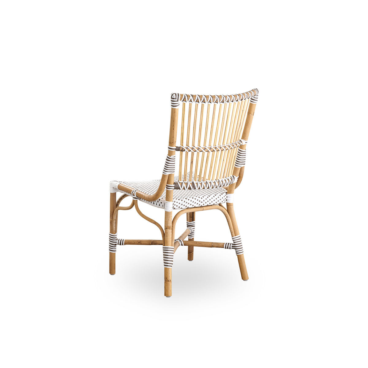 Back side view of the Monique dining chair.
Rattan frame with seat woven with ArtFibre in white with brown dots. Inspired by 1950s bistro design.