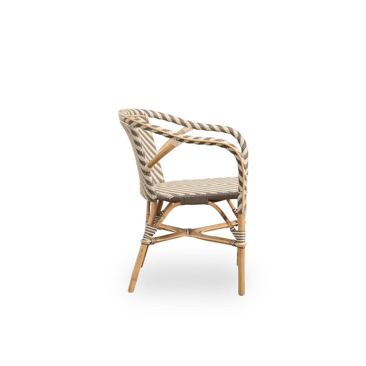 Plain side view of Madeleine dining armchair. Rattan frame with seat and backrest woven with ArtFibre in ivory and brown herringbone pattern. Inspired by 1950s bistro design.